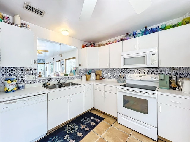 kitchen featuring white cabinetry, sink, backsplash, ceiling fan, and white appliances