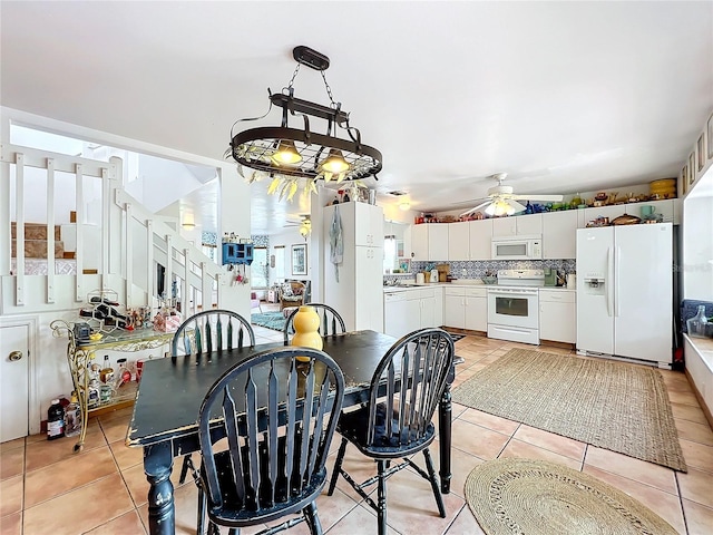 tiled dining space featuring ceiling fan