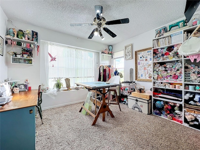 interior space featuring ceiling fan, carpet floors, and a textured ceiling