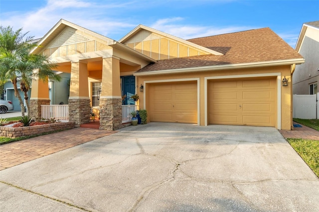 view of front facade featuring a porch and a garage