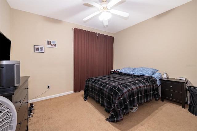 bedroom featuring light colored carpet and ceiling fan