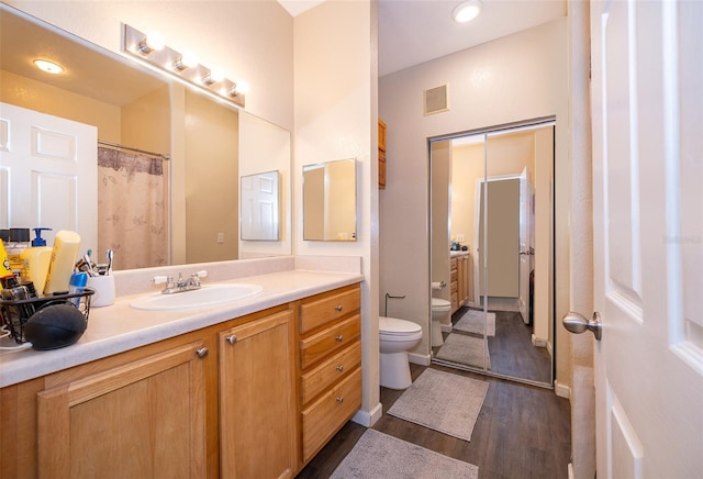 bathroom featuring hardwood / wood-style flooring, vanity, and toilet