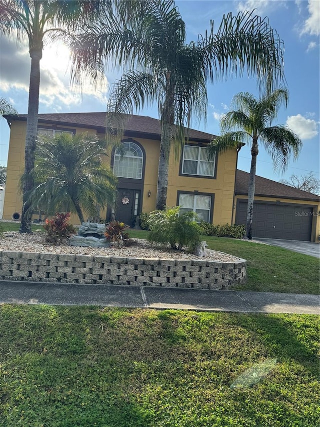 view of front of house featuring a garage and a front lawn