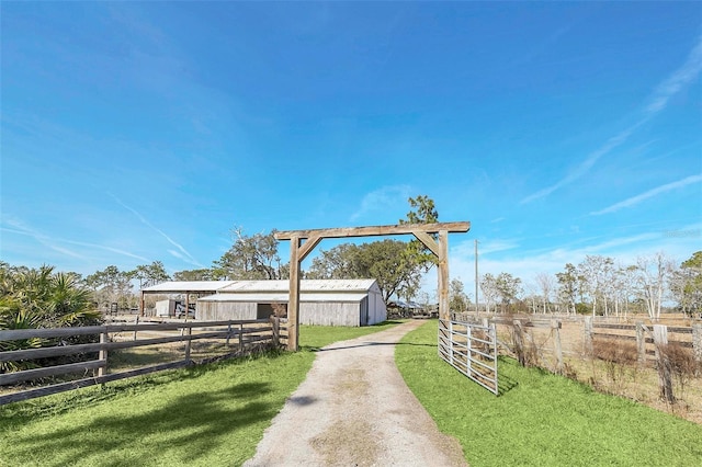 view of yard with a rural view and an outdoor structure