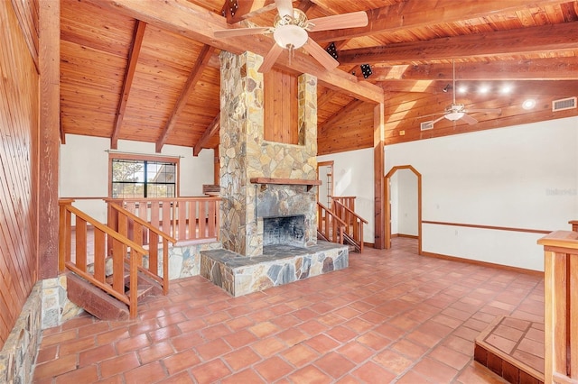 living room featuring beam ceiling, ceiling fan, wooden ceiling, and a fireplace