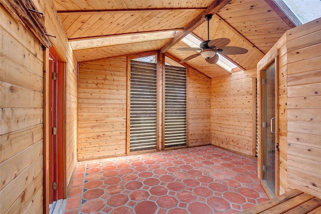 bonus room featuring wood ceiling, ceiling fan, wooden walls, and lofted ceiling with skylight