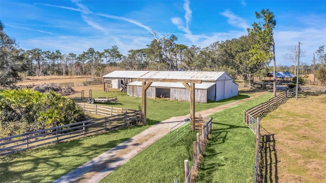 view of yard featuring an outdoor structure and a rural view