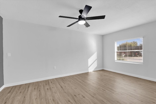 unfurnished room with ceiling fan and light wood-type flooring