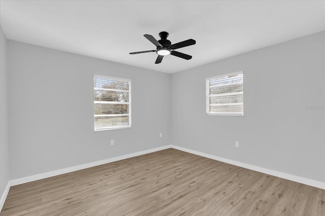 unfurnished room with ceiling fan, a healthy amount of sunlight, and light hardwood / wood-style flooring