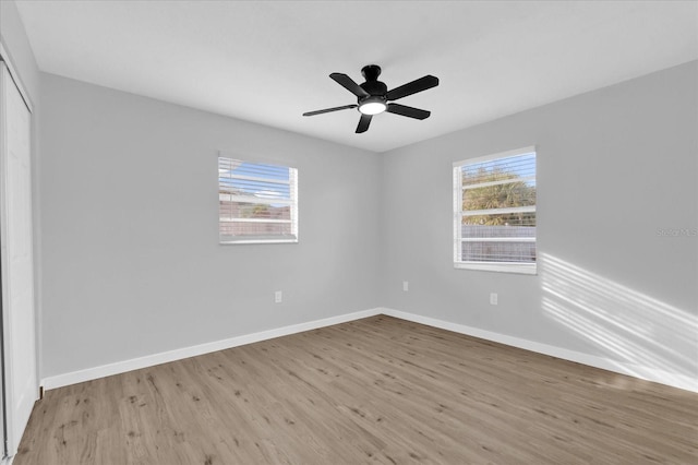 spare room featuring ceiling fan, plenty of natural light, and light hardwood / wood-style floors