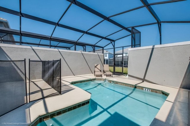 view of pool featuring a patio and glass enclosure