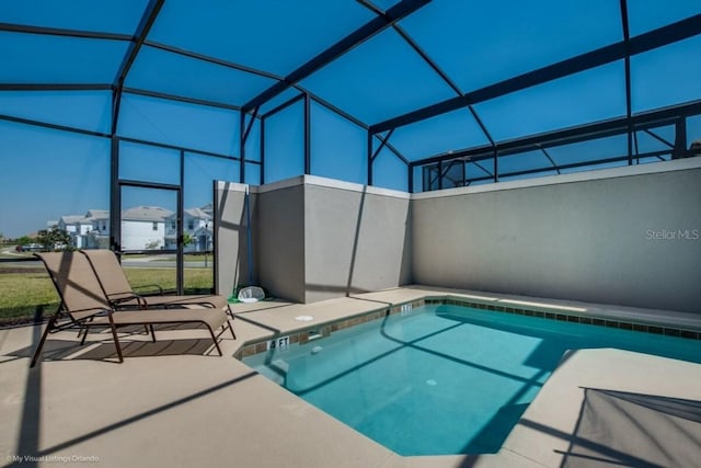 view of pool with a patio and a lanai