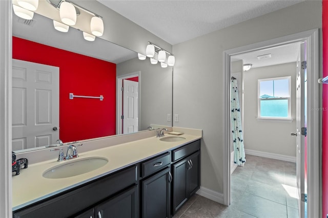 bathroom featuring vanity, tile patterned flooring, and walk in shower