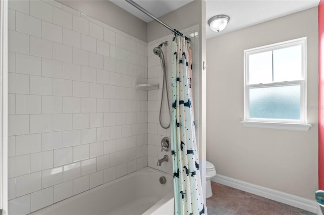 bathroom featuring shower / tub combo and toilet