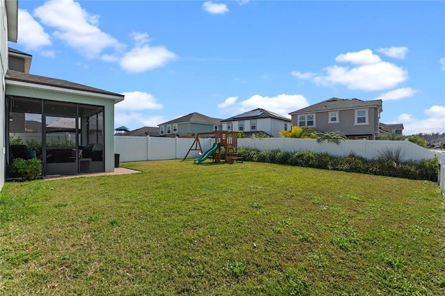 view of yard with a playground and a sunroom