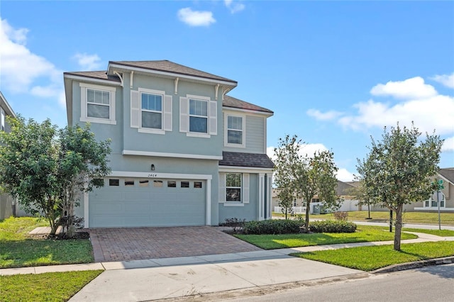 view of front of home featuring a garage and a front lawn