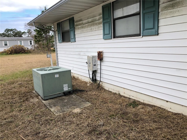 exterior space with cooling unit and a yard