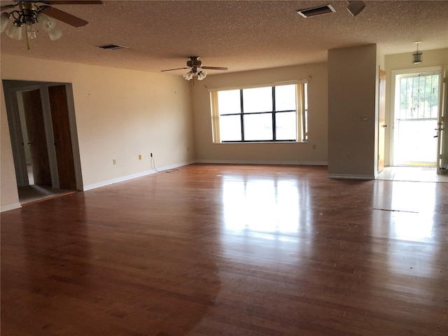 spare room featuring ceiling fan, dark hardwood / wood-style flooring, and a textured ceiling