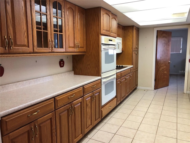 kitchen with white appliances and light tile patterned floors