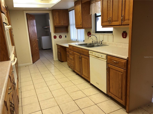 kitchen featuring light tile patterned flooring, sink, and white appliances