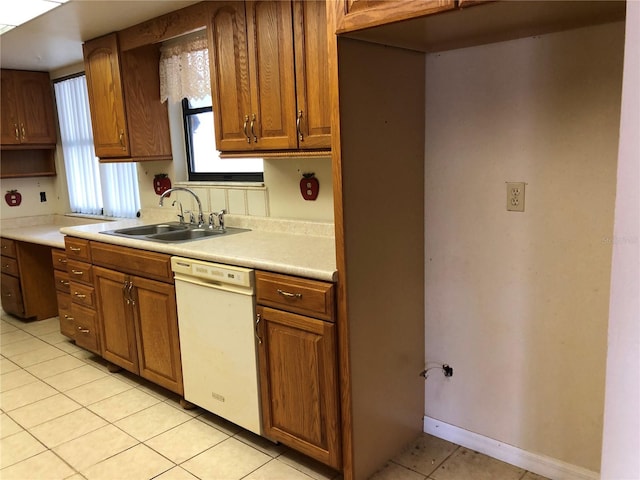 kitchen with sink, light tile patterned floors, and white dishwasher