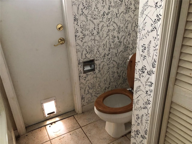 bathroom with tile patterned floors and toilet