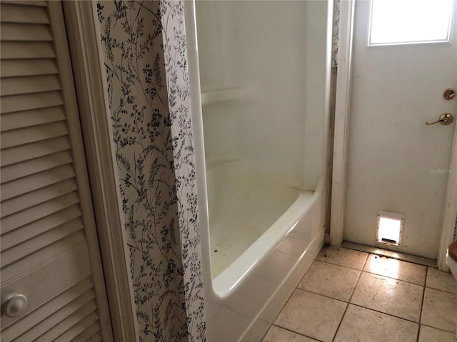 bathroom with a bathtub and tile patterned floors