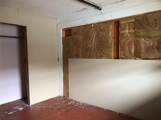 unfurnished bedroom with a textured ceiling