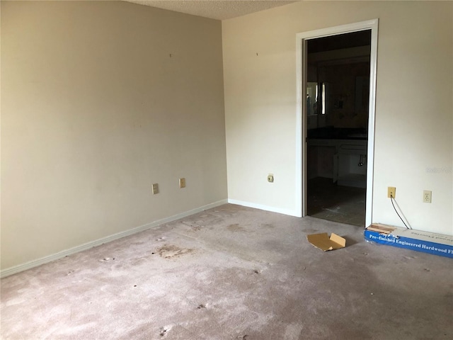 carpeted spare room with a textured ceiling