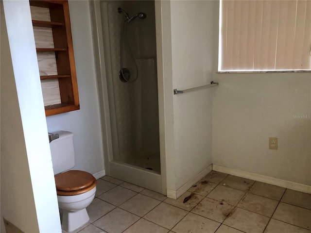 bathroom featuring walk in shower, tile patterned floors, and toilet