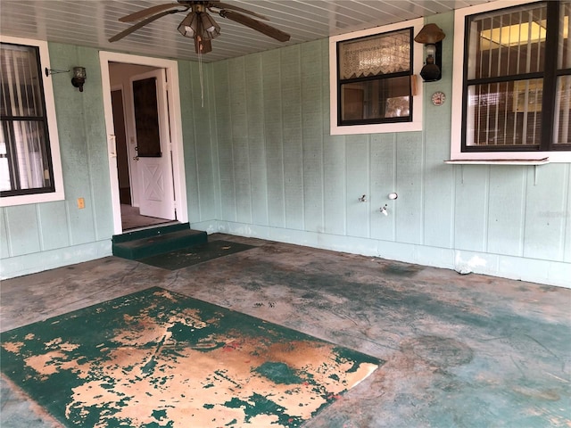 entrance to property with ceiling fan and a patio