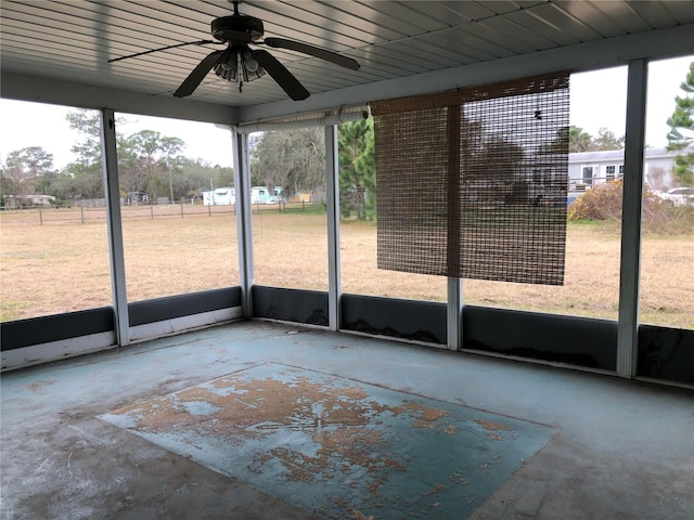 unfurnished sunroom with ceiling fan