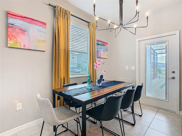 dining room with an inviting chandelier and light tile patterned floors