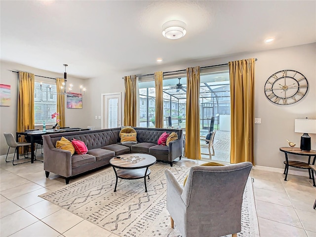 tiled living room featuring an inviting chandelier