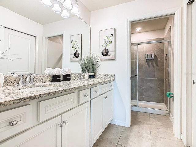 bathroom featuring tile patterned floors, vanity, and a shower with shower door