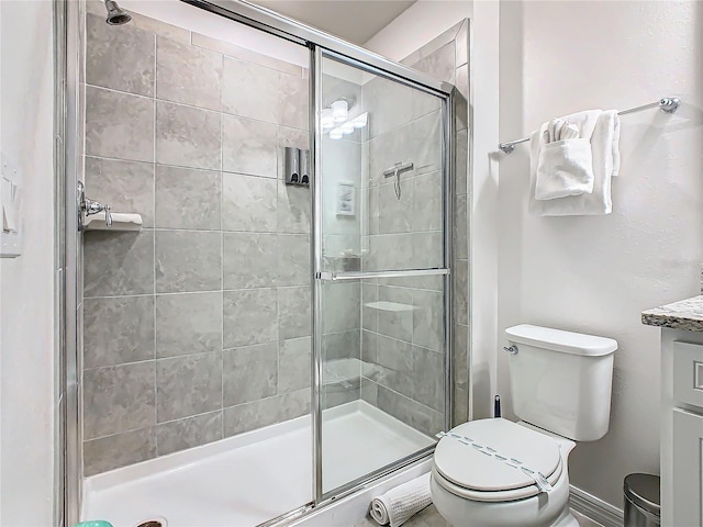 bathroom featuring an enclosed shower, vanity, and toilet