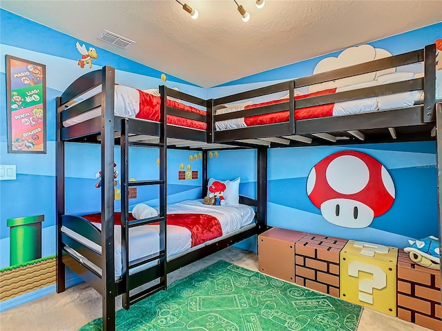 bedroom with concrete flooring and a textured ceiling