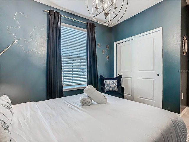 bedroom with a closet and a chandelier