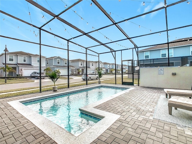 view of pool featuring a patio and glass enclosure