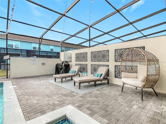 view of patio / terrace featuring grilling area and glass enclosure