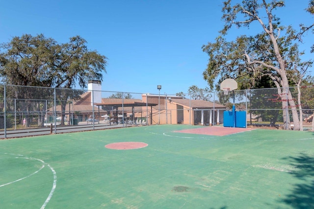 view of basketball court featuring community basketball court and fence