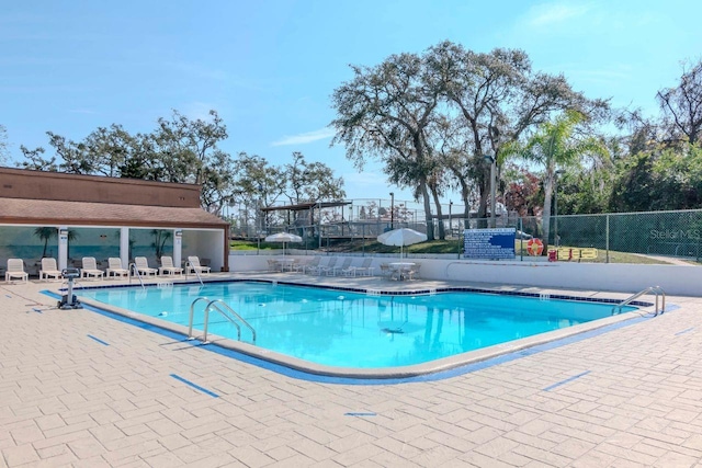 community pool featuring a patio area and fence