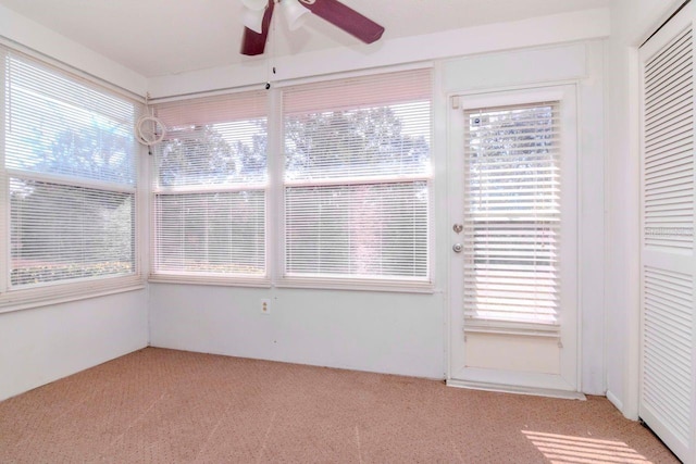 unfurnished sunroom with plenty of natural light and ceiling fan