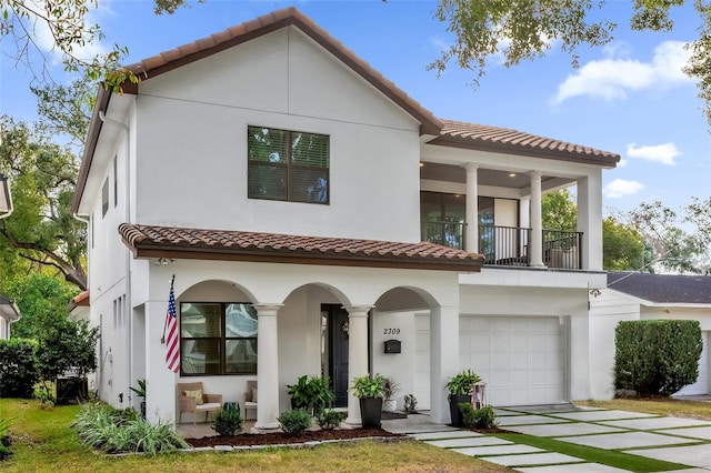 mediterranean / spanish-style house featuring a balcony and a garage