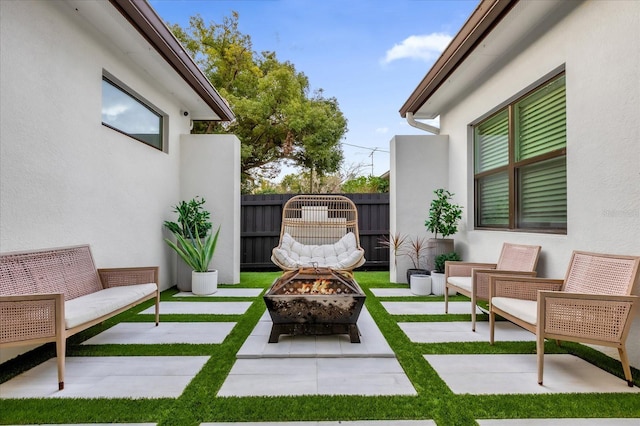 view of patio / terrace with an outdoor living space with a fire pit