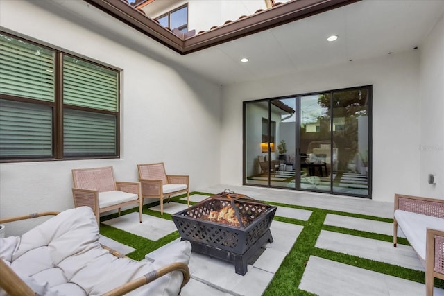 view of patio / terrace with an outdoor living space with a fire pit