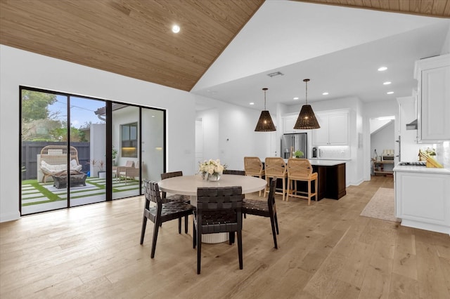 dining room featuring high vaulted ceiling, light hardwood / wood-style floors, and wooden ceiling