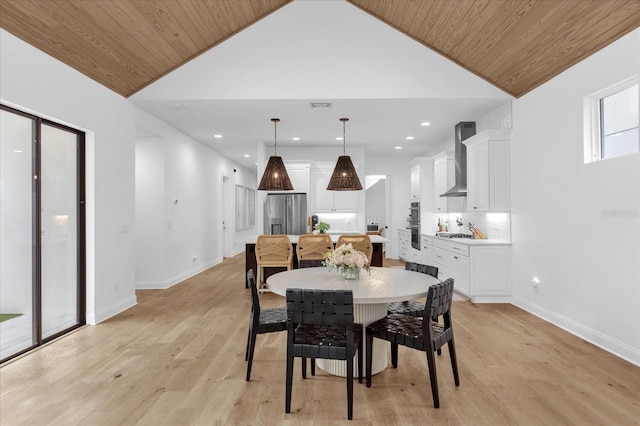 dining space featuring high vaulted ceiling, wooden ceiling, and light wood-type flooring