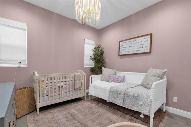 carpeted bedroom with an inviting chandelier