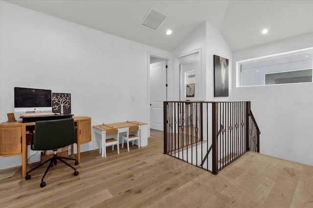 office space featuring vaulted ceiling and light hardwood / wood-style floors